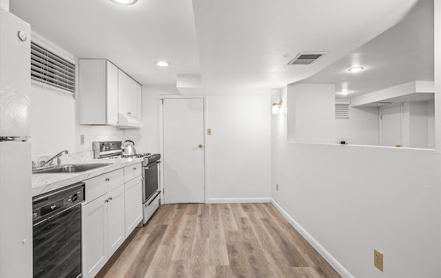 90 Gannet Dr, Commack, NY 11725 - kitchen with range with gas stovetop, dishwasher, under cabinet range hood, light wood-type flooring, and a sink