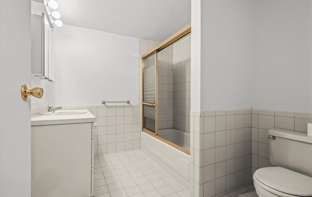 90 Gannet Dr, Commack, NY 11725 - bathroom featuring tile walls, toilet, tile patterned flooring, vanity, and shower / bath combination with glass door