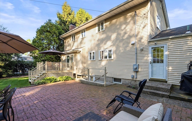 90 Gannet Dr, Commack, NY 11725 - back of house with a wooden deck, a patio area, and a chimney