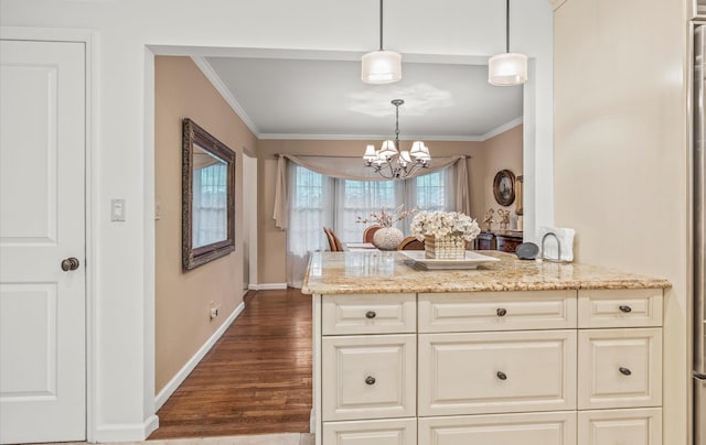90 Gannet Dr, Commack, NY 11725 - kitchen featuring ornamental molding, light stone counters, a chandelier, baseboards, and dark wood finished floors