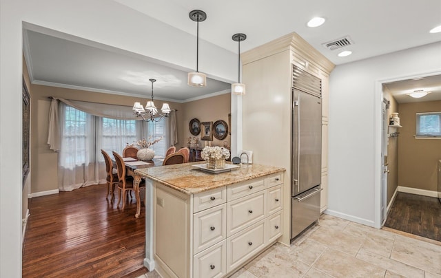 90 Gannet Dr, Commack, NY 11725 - kitchen with built in fridge, crown molding, light stone countertops, baseboards, and pendant lighting