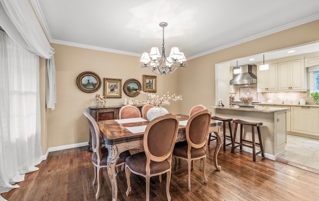 90 Gannet Dr, Commack, NY 11725 - dining room featuring a chandelier, crown molding, wood finished floors, and baseboards
