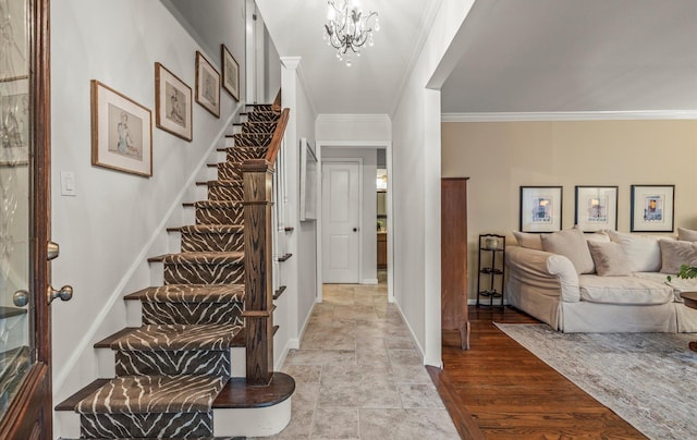 90 Gannet Dr, Commack, NY 11725 - entrance foyer featuring ornamental molding, stairway, a chandelier, stone finish floors, and baseboards