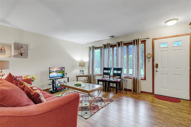 living area featuring light wood finished floors and baseboards
