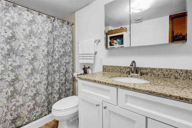 full bath featuring toilet, vanity, and tile patterned floors