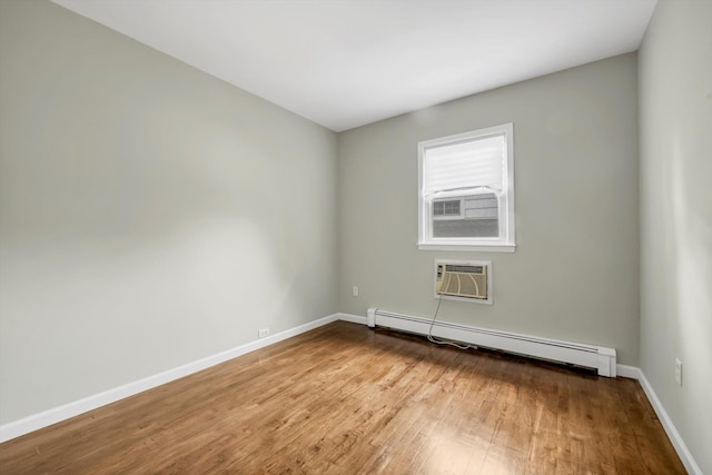76 Melrose Ave, Lynbrook, NY 11563 - empty room with baseboard heating, a wall mounted air conditioner, wood finished floors, and baseboards