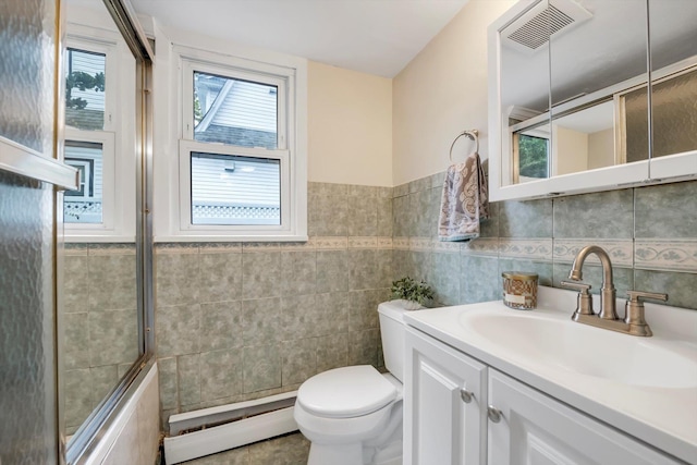 76 Melrose Ave, Lynbrook, NY 11563 - full bath with baseboard heating, tile walls, toilet, vanity, and a shower