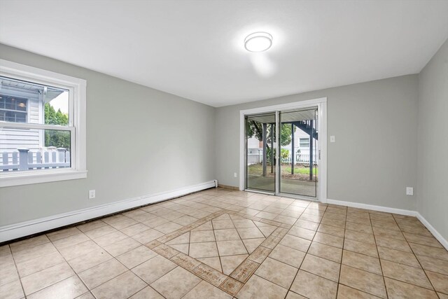 76 Melrose Ave, Lynbrook, NY 11563 - unfurnished room with baseboard heating, light tile patterned floors, and baseboards