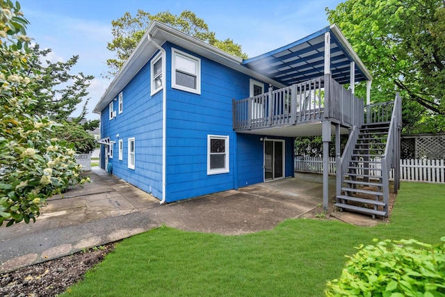 76 Melrose Ave, Lynbrook, NY 11563 - rear view of house featuring stairs, a wooden deck, and a patio area