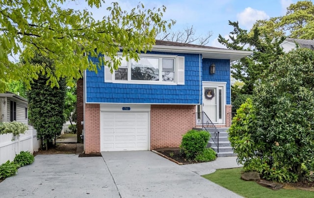 76 Melrose Ave, Lynbrook, NY 11563 - view of front facade featuring driveway, brick siding, and an attached garage