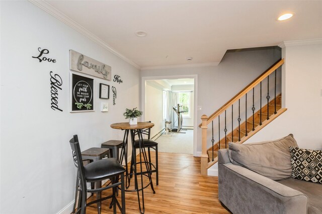living room featuring crown molding, light wood-style floors, baseboards, stairs, and recessed lighting