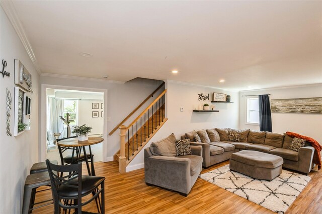 living area featuring ornamental molding, stairway, light wood-style floors, recessed lighting, and baseboards