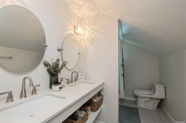 bathroom with toilet, vaulted ceiling, tile patterned flooring, double vanity, and baseboards