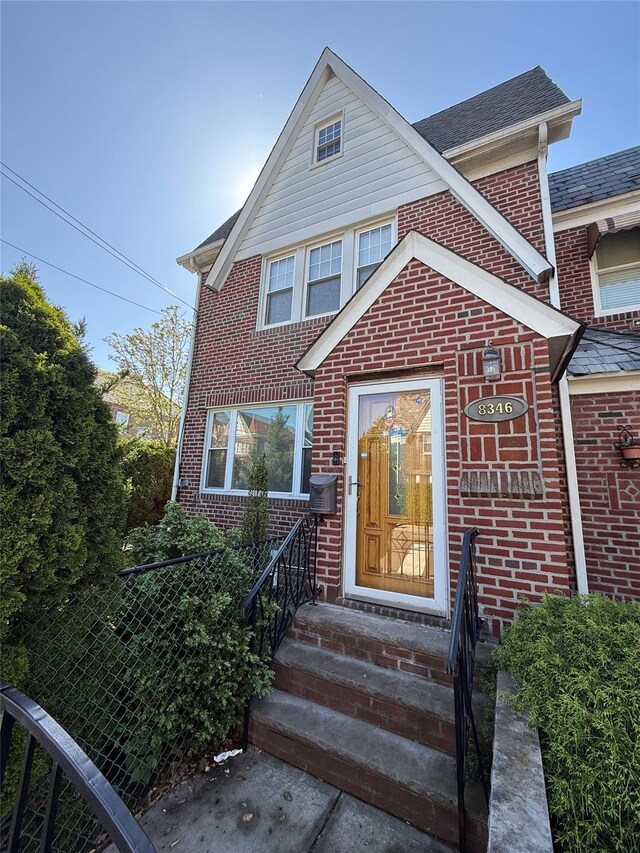 83-46 Penelope Ave, Middle Village, NY 11379 - view of front of home featuring brick siding, entry steps, and a shingled roof