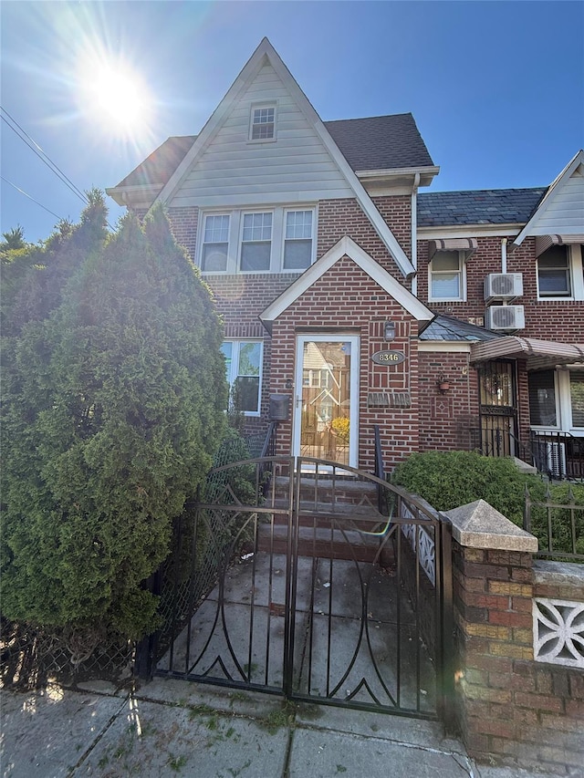 83-46 Penelope Ave, Middle Village, NY 11379 - view of front of home featuring brick siding, a fenced front yard, and a gate
