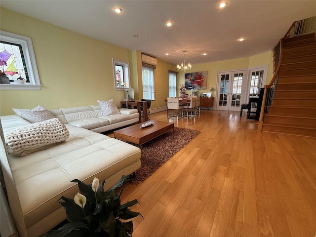 83-46 Penelope Ave, Middle Village, NY 11379 - living area featuring french doors, healthy amount of natural light, a chandelier, light wood finished floors, and recessed lighting