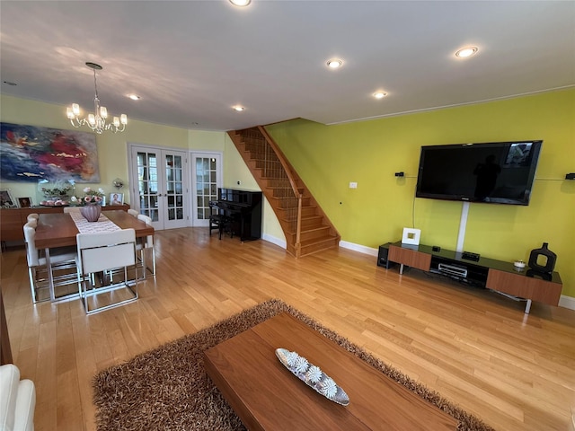 83-46 Penelope Ave, Middle Village, NY 11379 - living room featuring french doors, wood finished floors, stairway, a chandelier, and baseboards