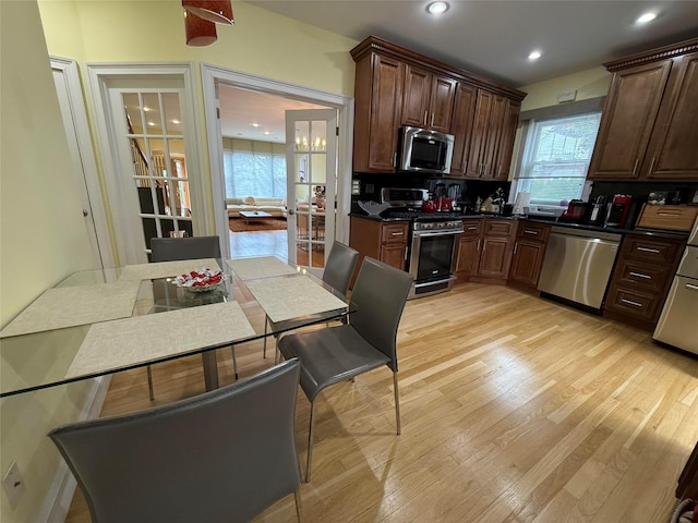 83-46 Penelope Ave, Middle Village, NY 11379 - kitchen with stainless steel appliances, dark countertops, plenty of natural light, light wood-style floors, and recessed lighting