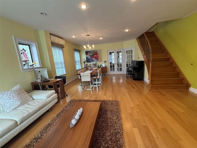 83-46 Penelope Ave, Middle Village, NY 11379 - living room with a chandelier, french doors, a wall unit AC, stairway, and light wood-style flooring