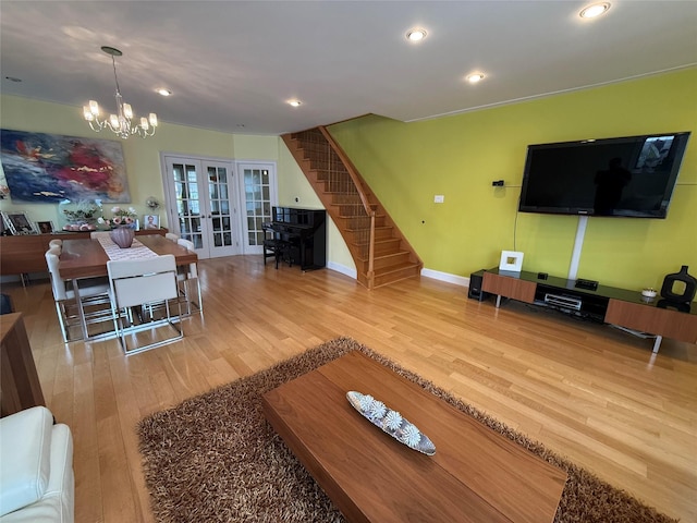 83-46 Penelope Ave, Middle Village, NY 11379 - living area with french doors, wood finished floors, stairway, a chandelier, and recessed lighting