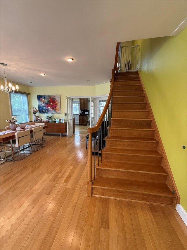 83-46 Penelope Ave, Middle Village, NY 11379 - stairs with wood finished floors, a chandelier, healthy amount of natural light, baseboards, and recessed lighting