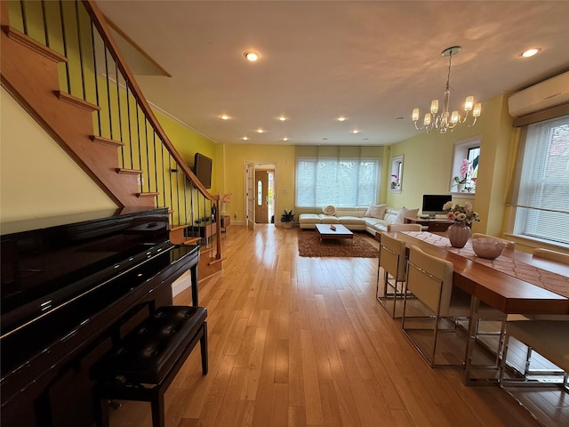 83-46 Penelope Ave, Middle Village, NY 11379 - dining space with stairs, a wall mounted AC, a chandelier, wood-type flooring, and recessed lighting
