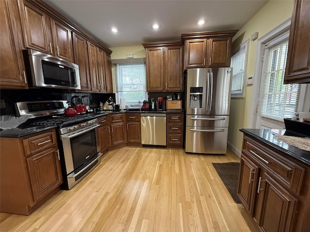 83-46 Penelope Ave, Middle Village, NY 11379 - kitchen with appliances with stainless steel finishes, light wood-style floors, decorative backsplash, recessed lighting, and dark brown cabinetry