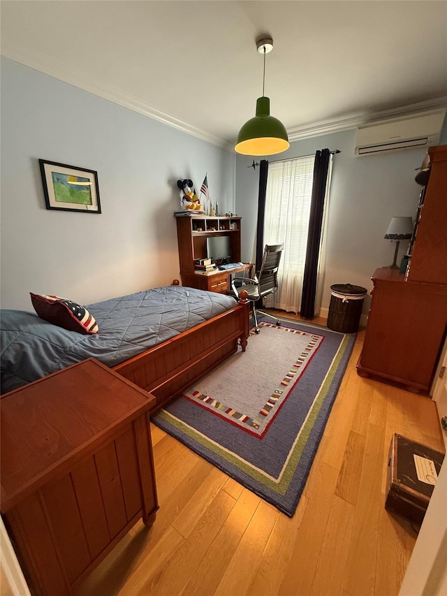 83-46 Penelope Ave, Middle Village, NY 11379 - bedroom with an AC wall unit, ornamental molding, and light wood-style flooring