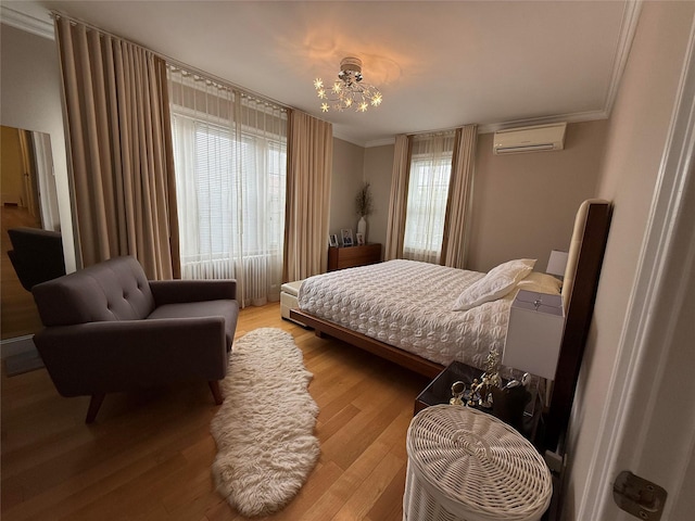 83-46 Penelope Ave, Middle Village, NY 11379 - bedroom featuring crown molding, light wood-type flooring, a chandelier, and a wall mounted air conditioner