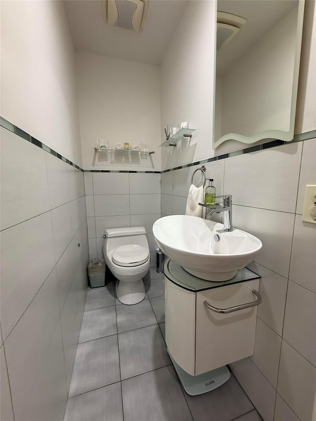83-46 Penelope Ave, Middle Village, NY 11379 - half bath featuring tile walls, toilet, vanity, and tile patterned flooring