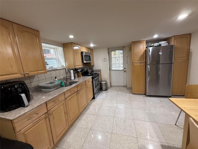 83-46 Penelope Ave, Middle Village, NY 11379 - kitchen featuring stainless steel appliances, healthy amount of natural light, tasteful backsplash, recessed lighting, and light stone counters