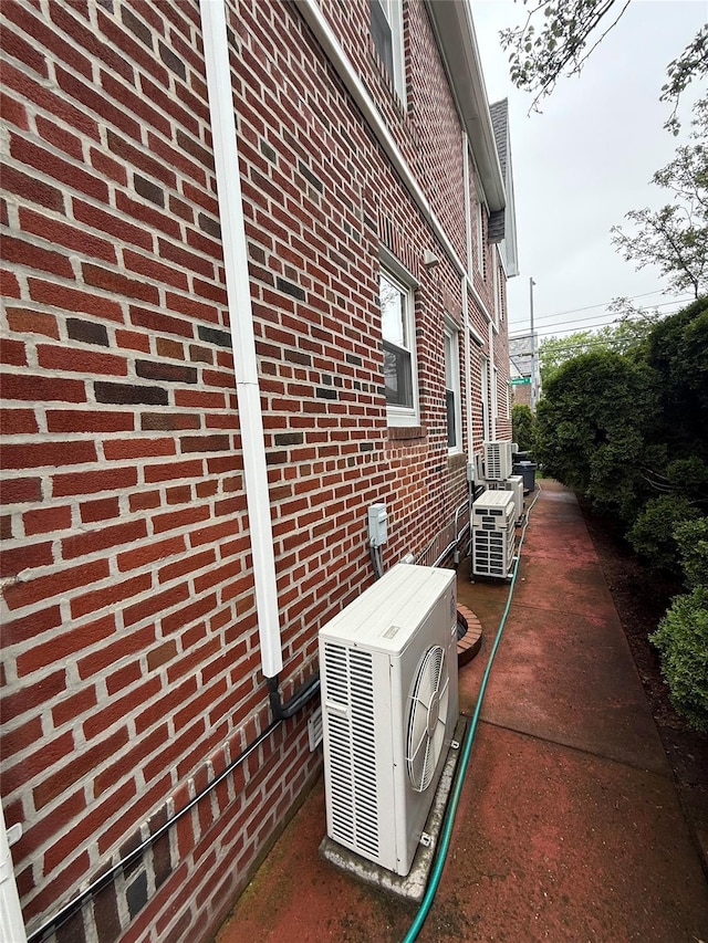 83-46 Penelope Ave, Middle Village, NY 11379 - view of side of property featuring ac unit, brick siding, and central air condition unit