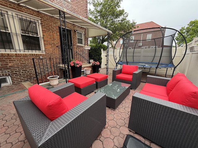 83-46 Penelope Ave, Middle Village, NY 11379 - view of patio / terrace with a trampoline, an outdoor living space, and fence