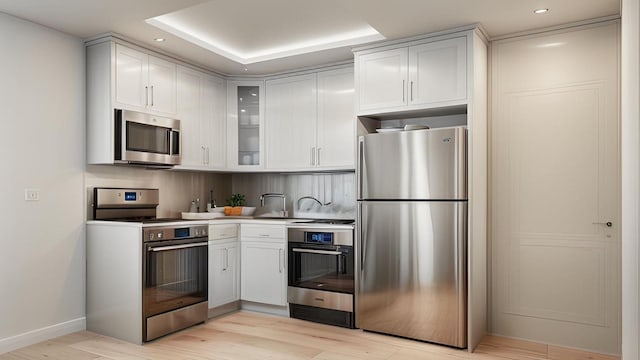 4518 Richardson Ave, Bronx, NY 10470 - kitchen featuring stainless steel appliances, glass insert cabinets, light wood-style floors, baseboards, and tasteful backsplash