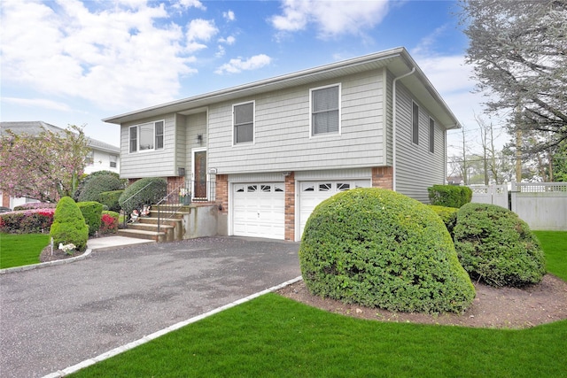 2228 Stacey Ct, North Bellmore, NY 11710 - split foyer home with driveway, a garage, fence, and brick siding