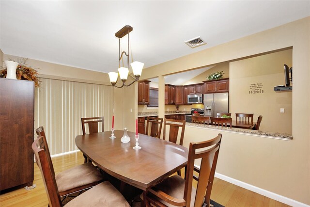 2228 Stacey Ct, North Bellmore, NY 11710 - dining room with light wood-type flooring, a chandelier, and baseboards