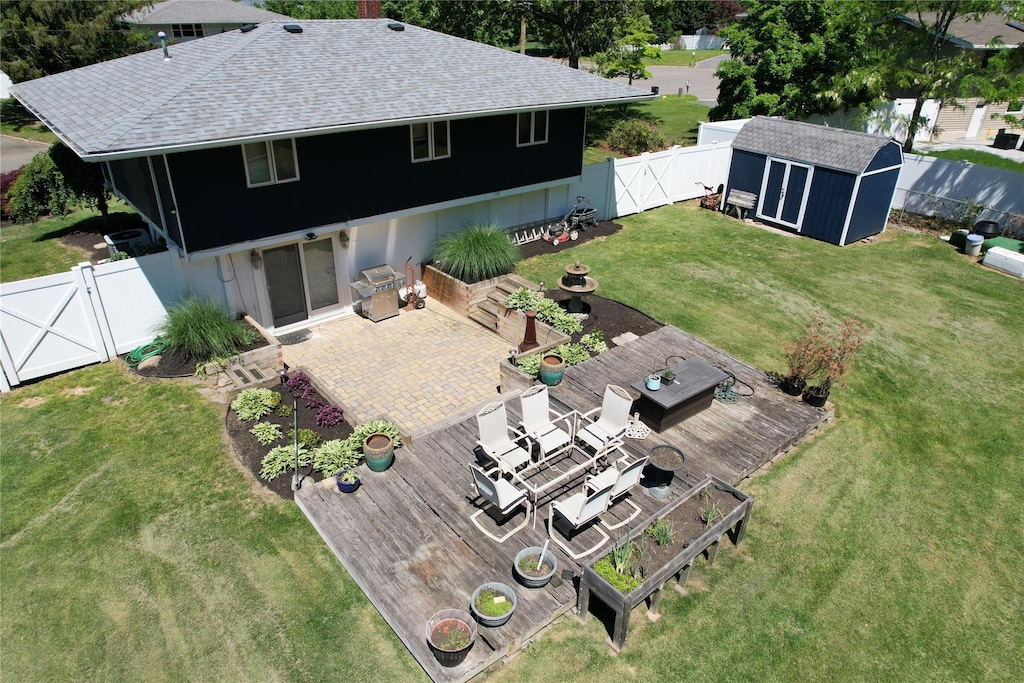 49 Bobcat Ln, East Setauket, NY 11733 - rear view of property featuring a gate, a shingled roof, a wooden deck, and a chimney