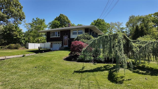 49 Bobcat Ln, East Setauket, NY 11733 - raised ranch with an attached garage and a chimney