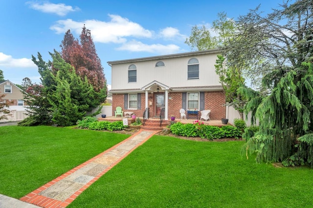 2346 Post St, East Meadow, NY 11554 - view of front of house with brick siding and a front yard