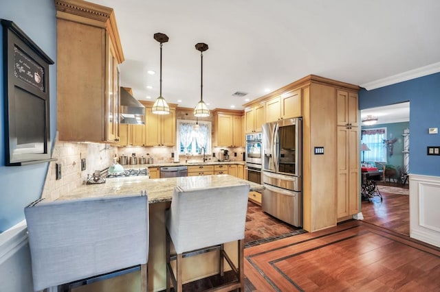 2346 Post St, East Meadow, NY 11554 - kitchen with stainless steel appliances, a peninsula, plenty of natural light, dark wood-style flooring, and crown molding