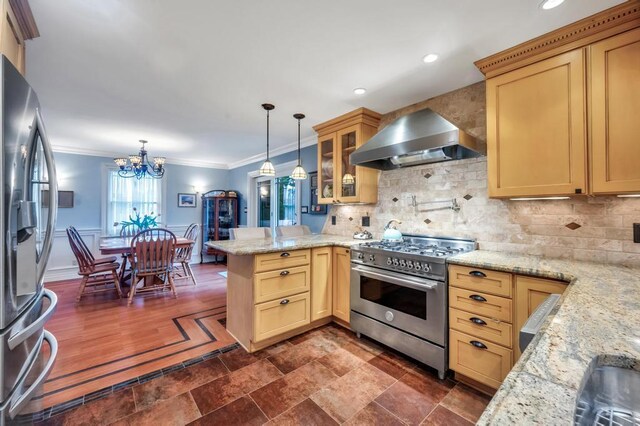 2346 Post St, East Meadow, NY 11554 - kitchen with stainless steel appliances, wall chimney range hood, a peninsula, a chandelier, and decorative backsplash