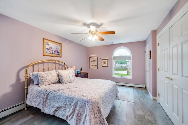 2346 Post St, East Meadow, NY 11554 - bedroom with a baseboard heating unit, wood finished floors, and a closet