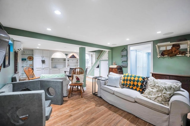 2346 Post St, East Meadow, NY 11554 - living area with an AC wall unit, light wood-style floors, recessed lighting, and stairway