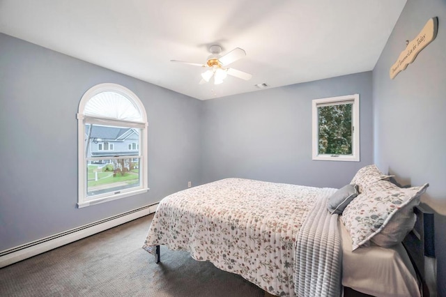 2346 Post St, East Meadow, NY 11554 - bedroom featuring a baseboard heating unit, multiple windows, carpet, and ceiling fan