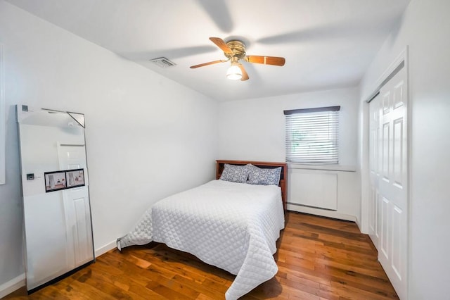 2346 Post St, East Meadow, NY 11554 - bedroom featuring a baseboard heating unit, hardwood / wood-style flooring, a closet, and a ceiling fan