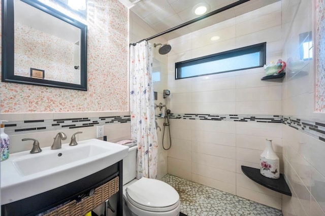 2346 Post St, East Meadow, NY 11554 - full bathroom with a tile shower, toilet, wallpapered walls, tile walls, and vanity