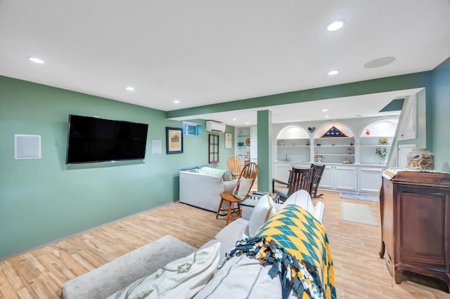 2346 Post St, East Meadow, NY 11554 - living area featuring an AC wall unit, light wood-type flooring, and recessed lighting