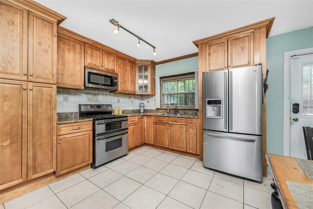 2733 Tenbroeck Ave, Bronx, NY 10469 - kitchen with appliances with stainless steel finishes, dark stone countertops, decorative backsplash, glass insert cabinets, and brown cabinetry