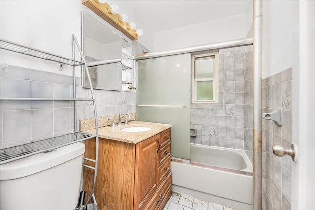 2733 Tenbroeck Ave, Bronx, NY 10469 - full bathroom with toilet, vanity, decorative backsplash, combined bath / shower with glass door, and tile walls
