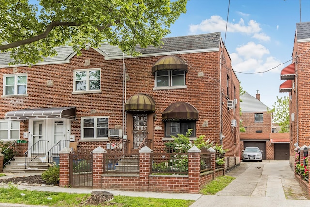 2733 Tenbroeck Ave, Bronx, NY 10469 - view of property featuring driveway, brick siding, a garage, and a shingled roof